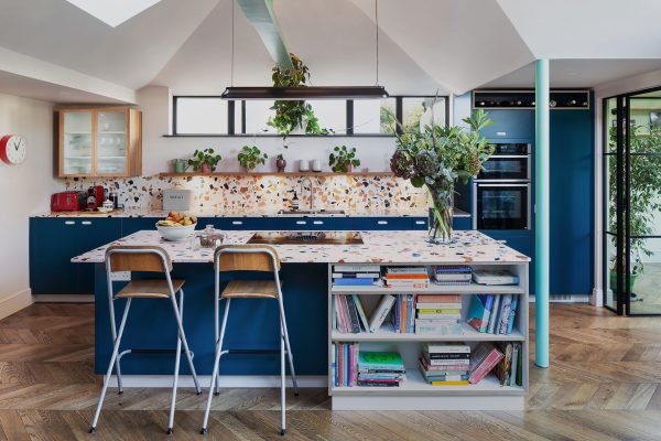 Family kitchen in Balham with an island and dining table, closely linked to the garden.