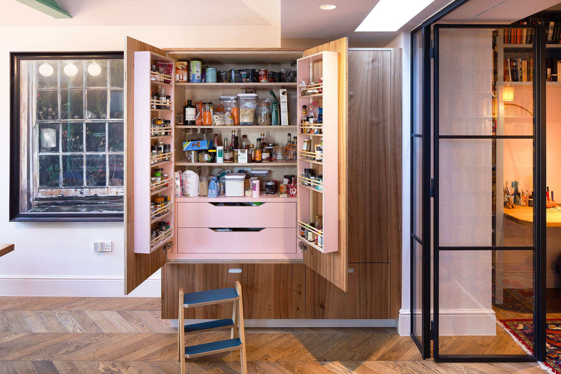 Open plan family kitchen in Balham with blue cabinets, a large terrazzo topped island and warm Elm wood tall cupboards.