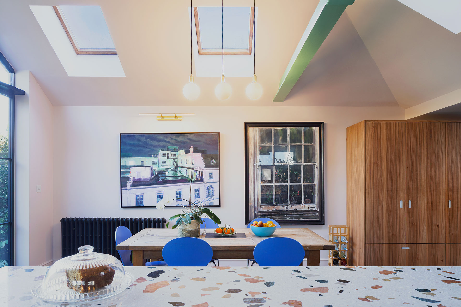 Family kitchen in Balham with an island and dining table, closely linked to the garden.