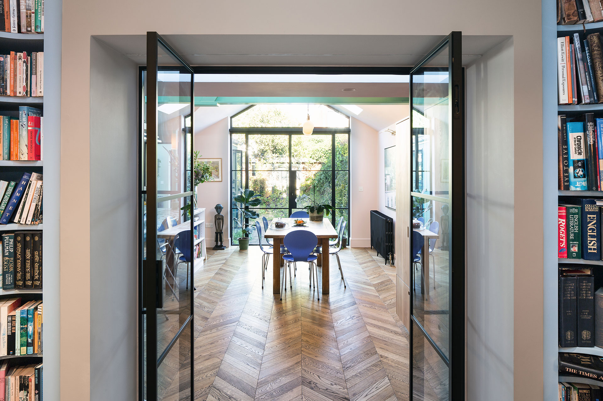Family kitchen in Balham with an island and dining table, closely linked to the garden.