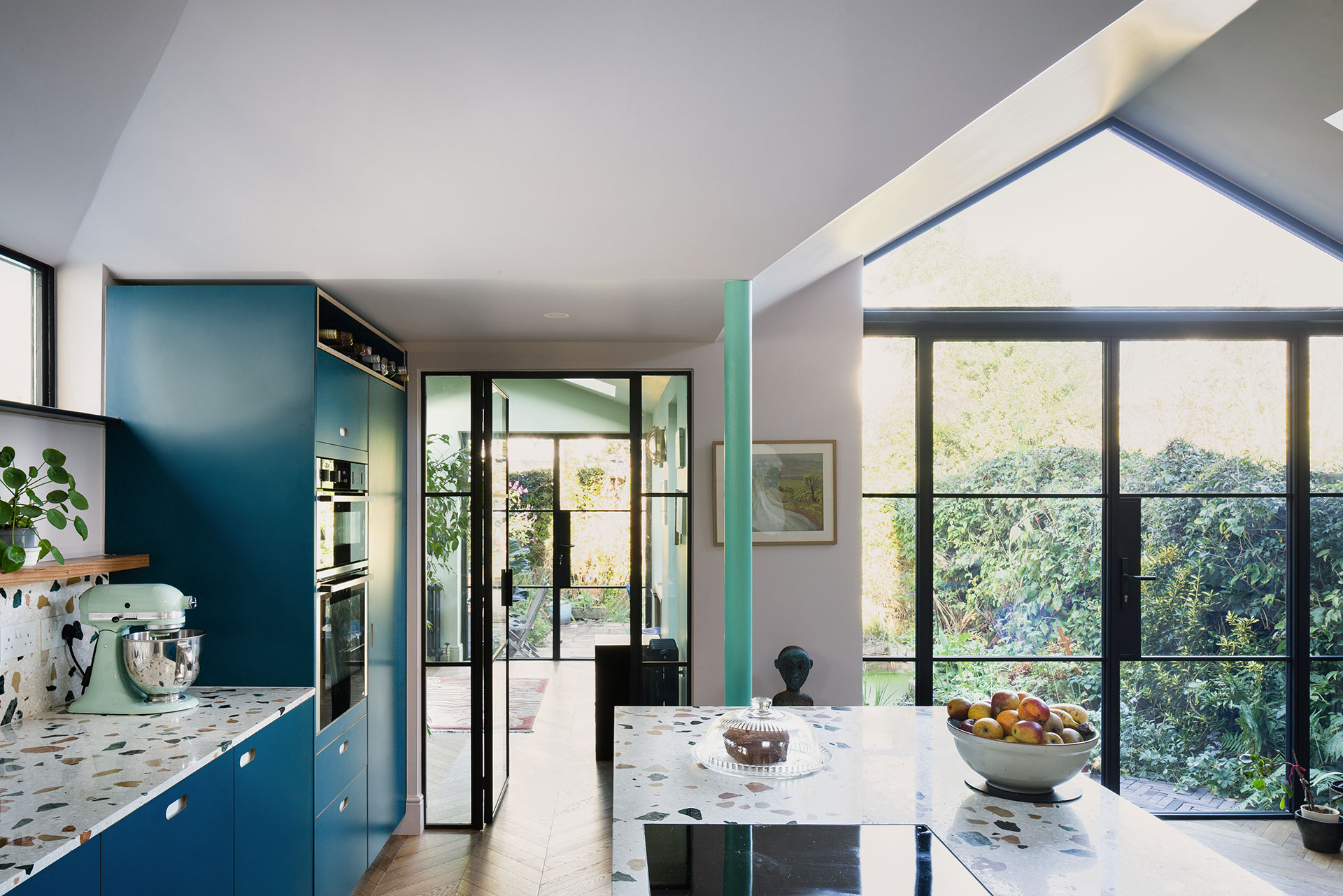 Family kitchen in Balham with an island and dining table, closely linked to the garden.