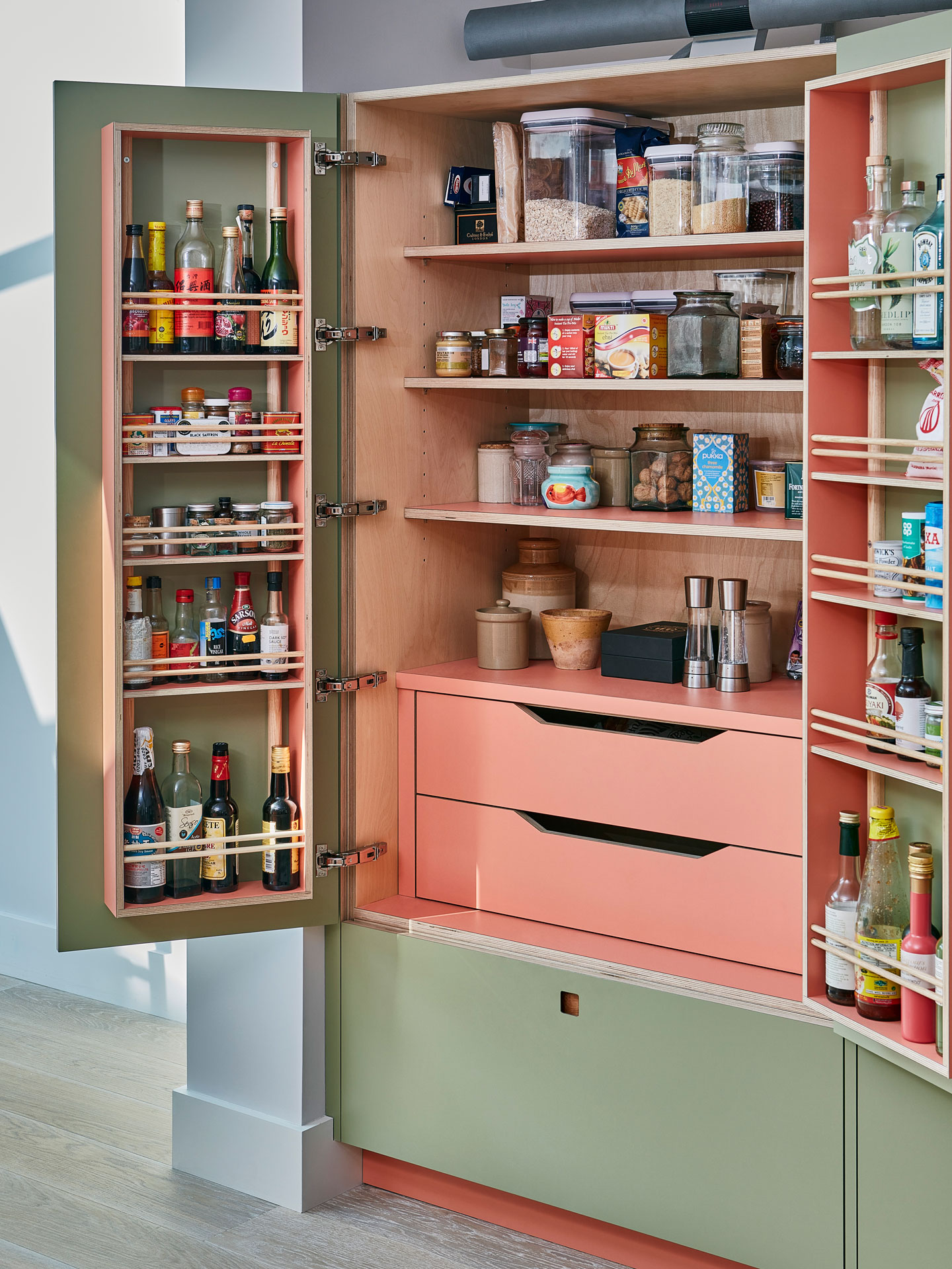 Pink and green Pluck kitchen with natural stone in Dulwich village.