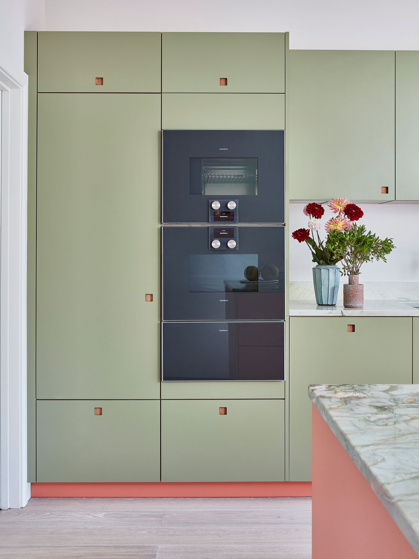 Pink and green Pluck kitchen with natural stone in Dulwich village.