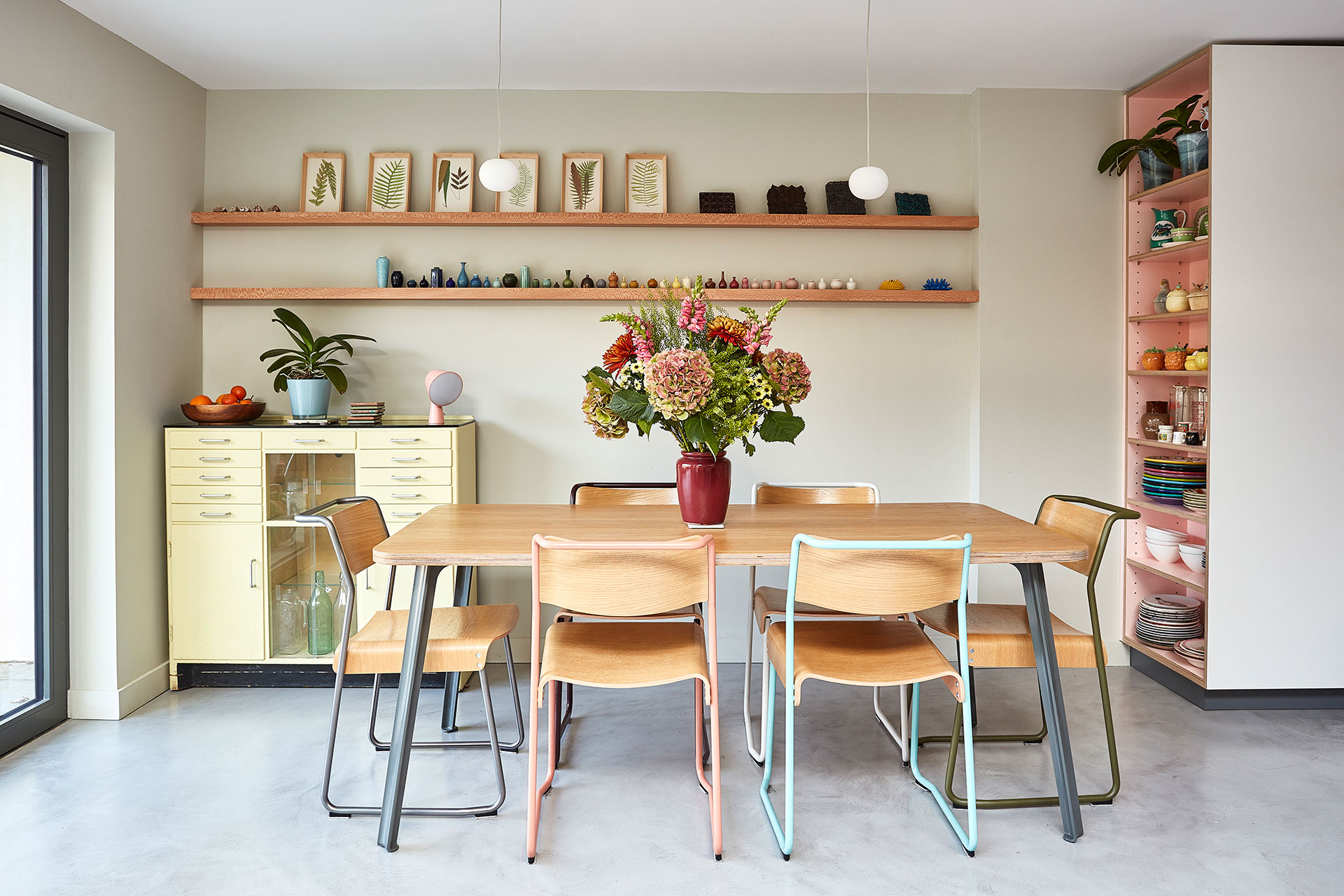 Cosy dining area with pastel coloured furniture.