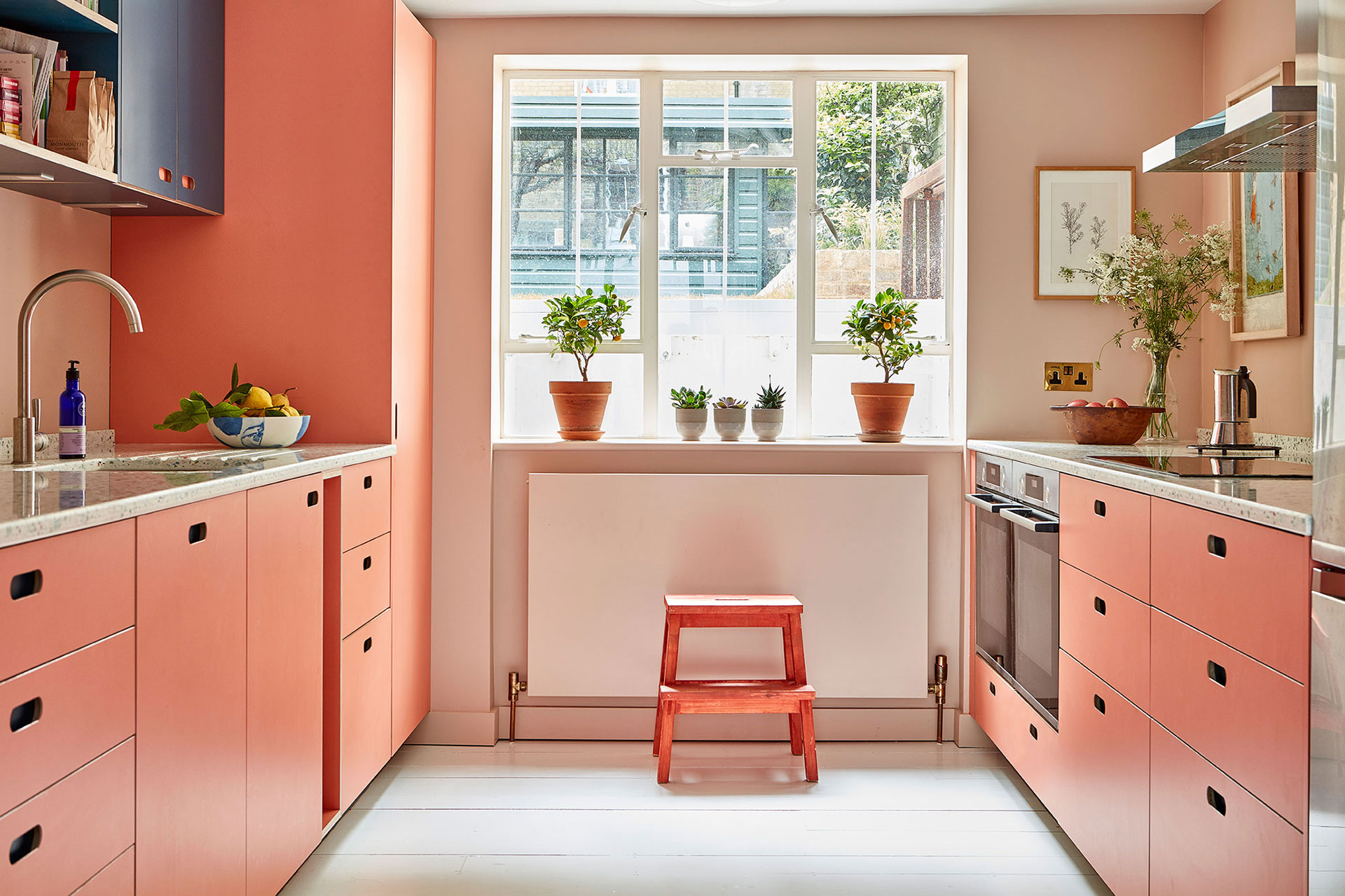 Blue, coral pink and wood Pluck cabinetry with glass terrazzo in an Islington townhouse kitchen.
