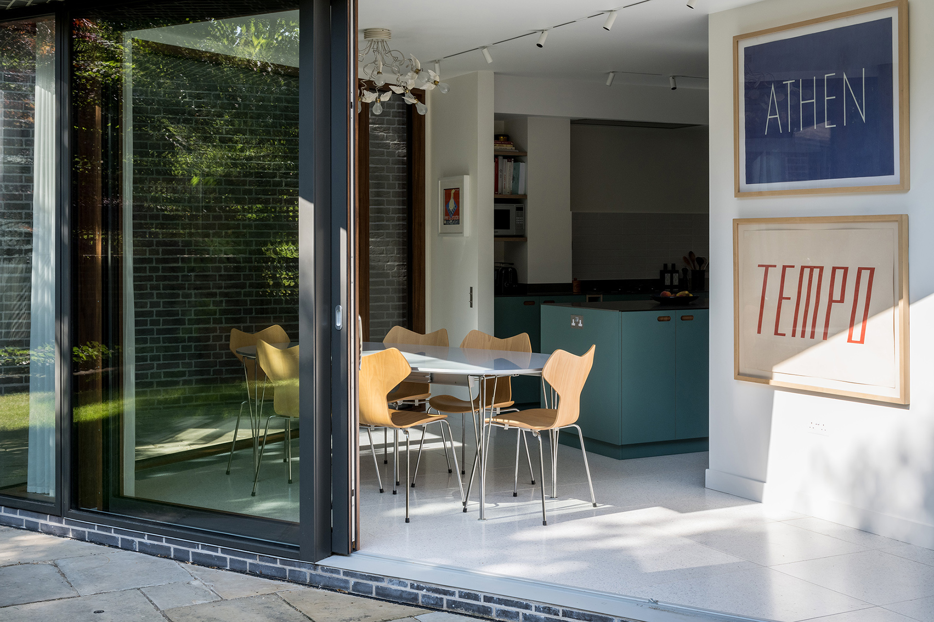 Cherry wood and green kitchen with stainless steel worktops.