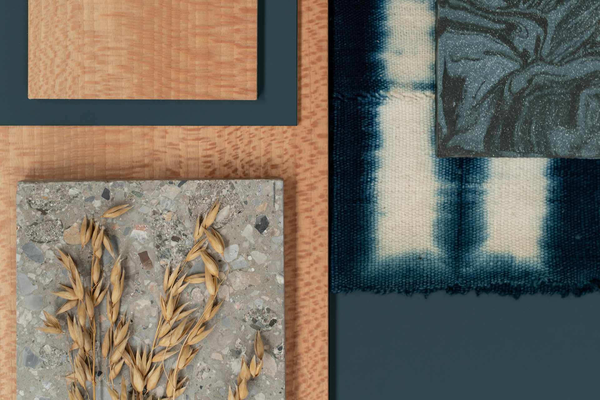 Navy fenix and London Plane wood with tie die fabric, terrazzo, a marbled tile and oats providing kitchen colour inspiration.