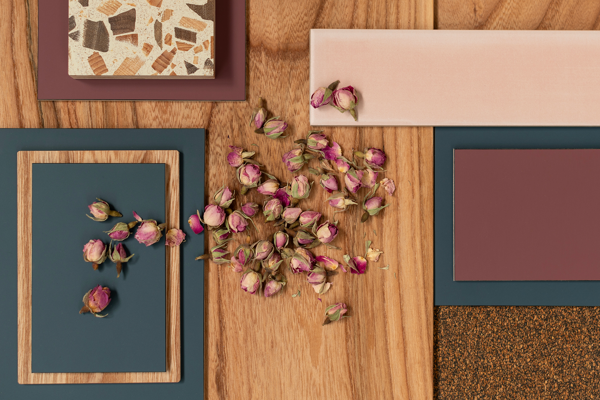 Soft navy blue and raspberry red fenix kitchen colour inspiration with Elm wood, cork, terrazzo, a pink tile and rosebuds.