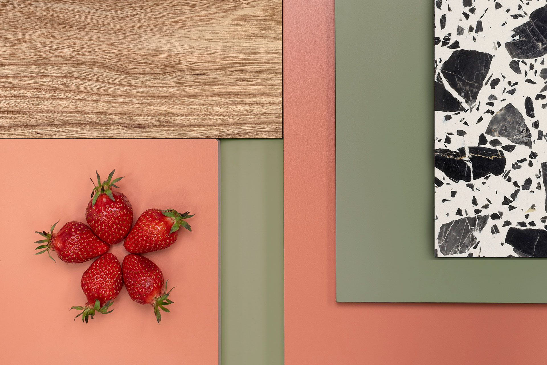 Kitchen colour inspiration with coral pink, soft khaki green, Elm wood, black and white terrazzo and red seeded strawberries.