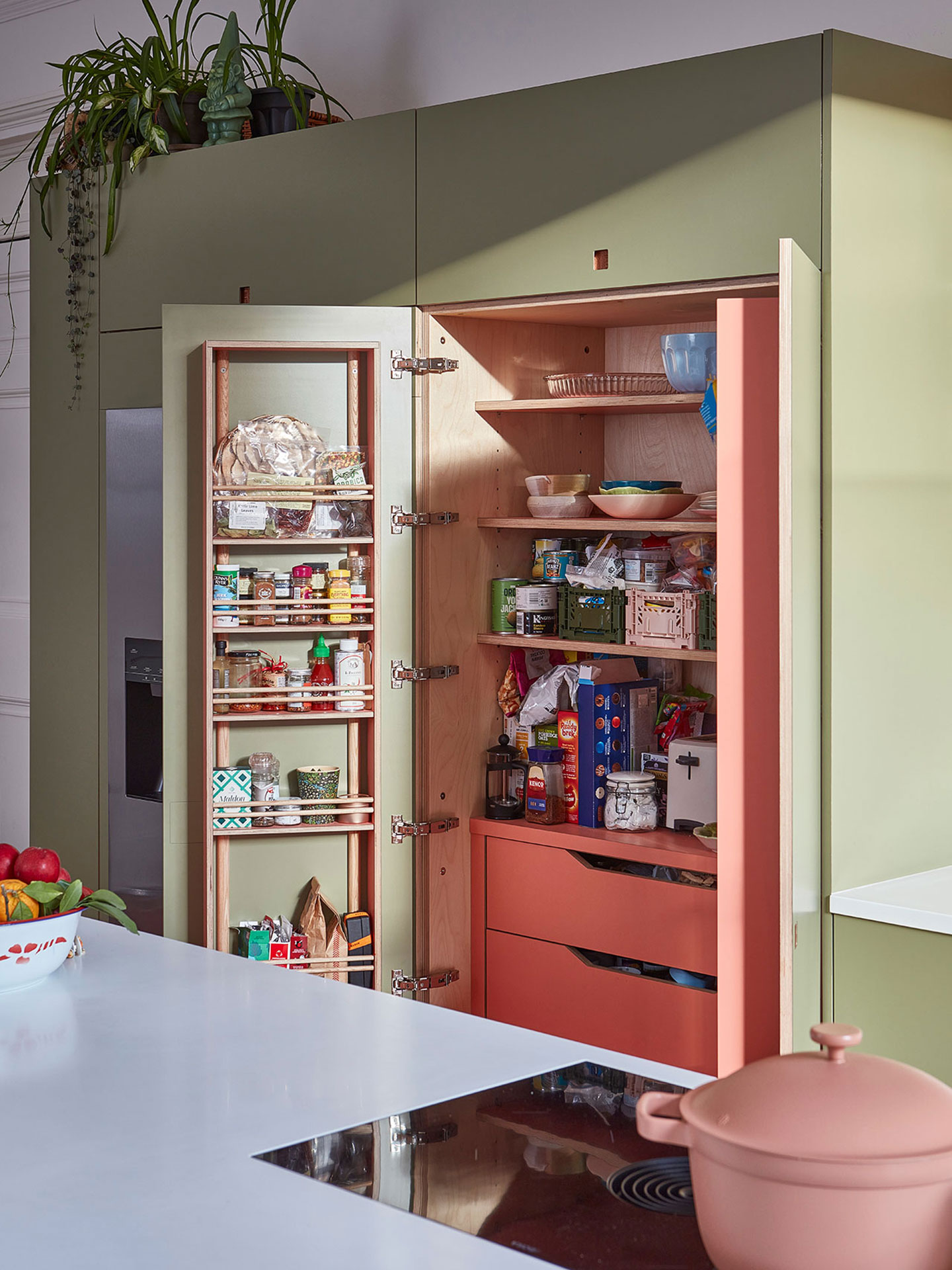 A Pluck larder in an open plan pink and green kitchen in a Georgian Edinburgh home.