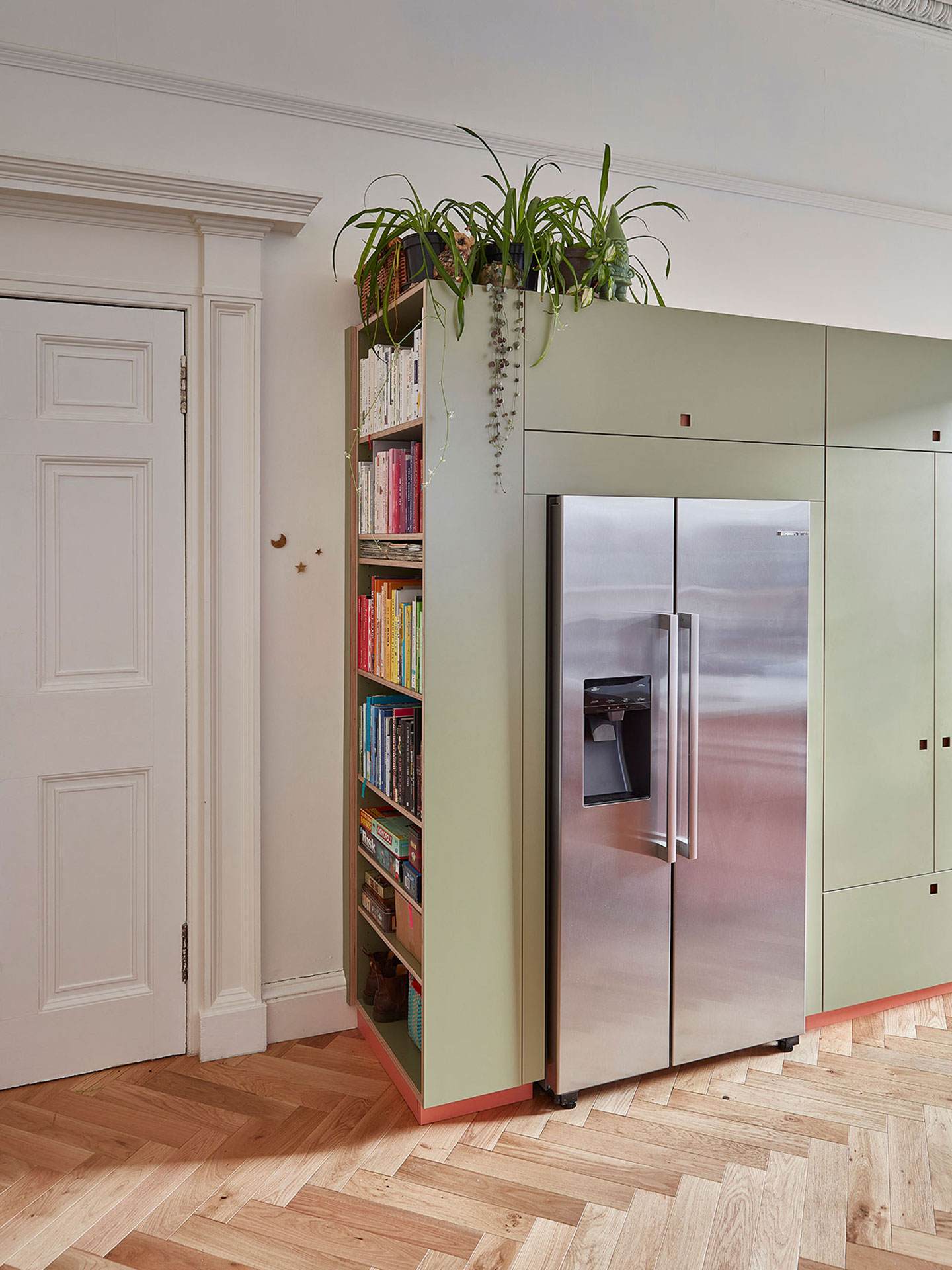 Open plan pink and green Pluck kitchen in a Georgian Edinburgh home.