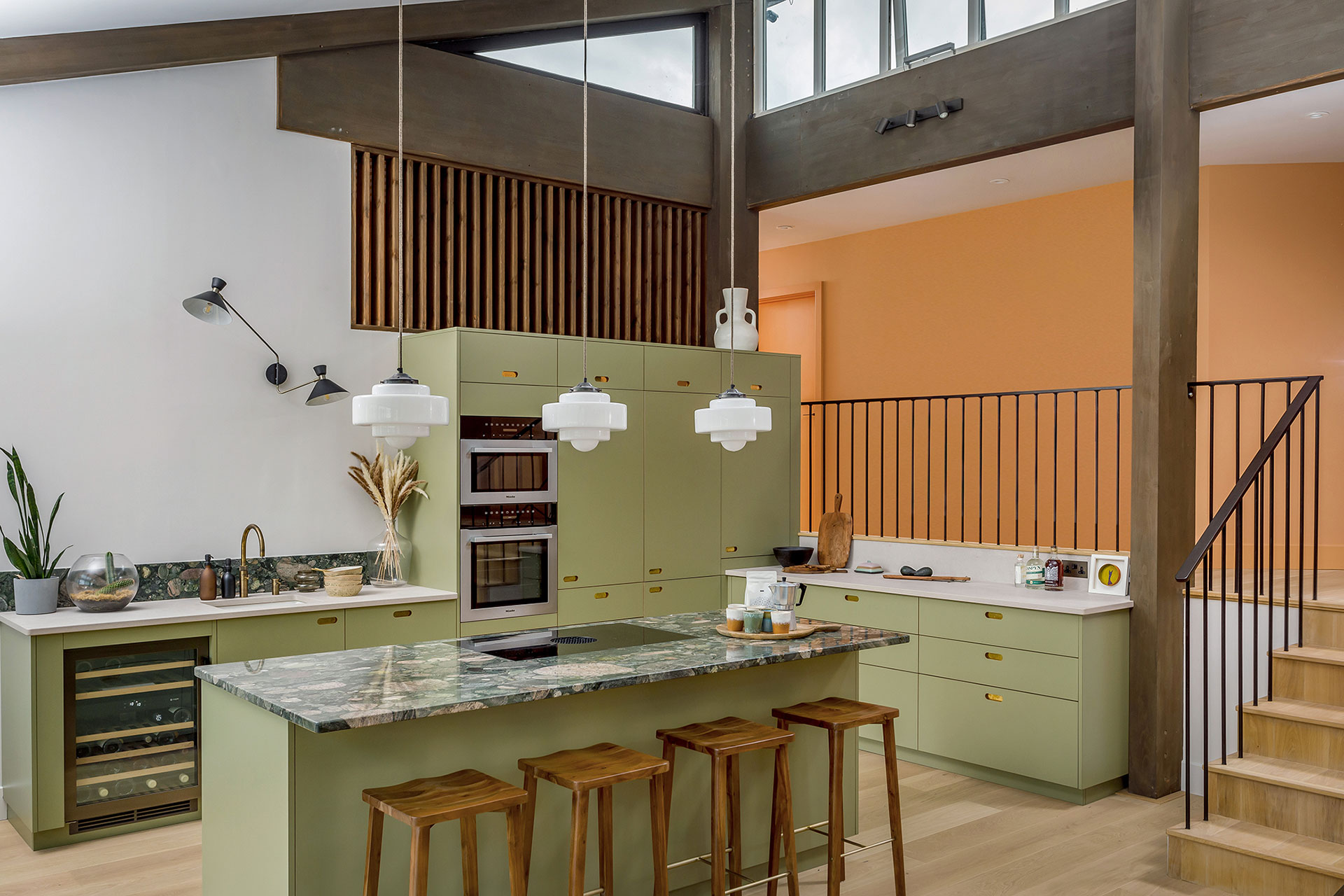 A house in Padstow that has panoramic views over Cornwall’s coast with a khaki green Pluck kitchen and brass handles.