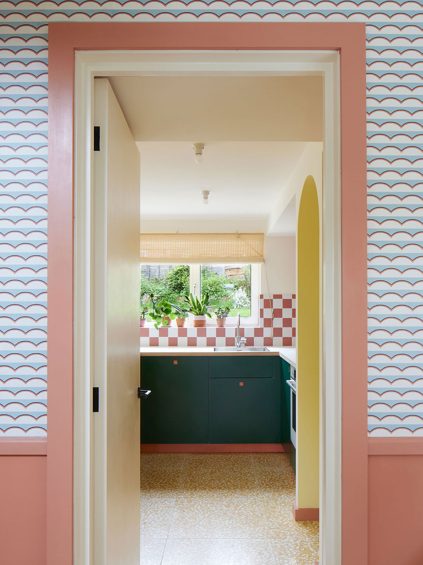 Colourful kitchen with three Pluck colours, checkerboard splashback and terrazzo floor.