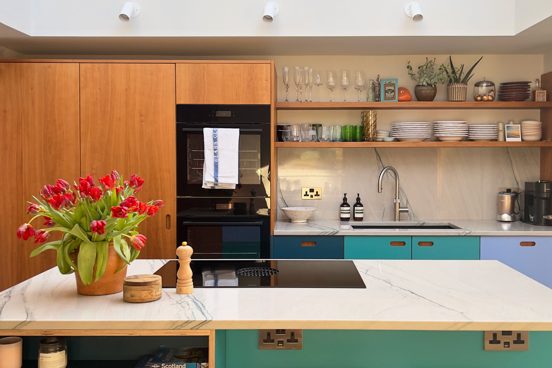 Shades of blue and Cherry wood Pluck cabinetry topped with swirling natural stone marble in a Grade II listed Victorian townhouse.