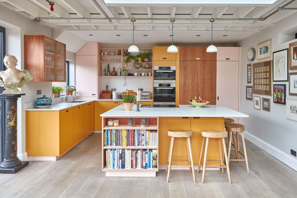 Colourful family kitchen in Birmingham including soft pink, mustard yellow and Cherry and London Plane wood Pluck cabinets.