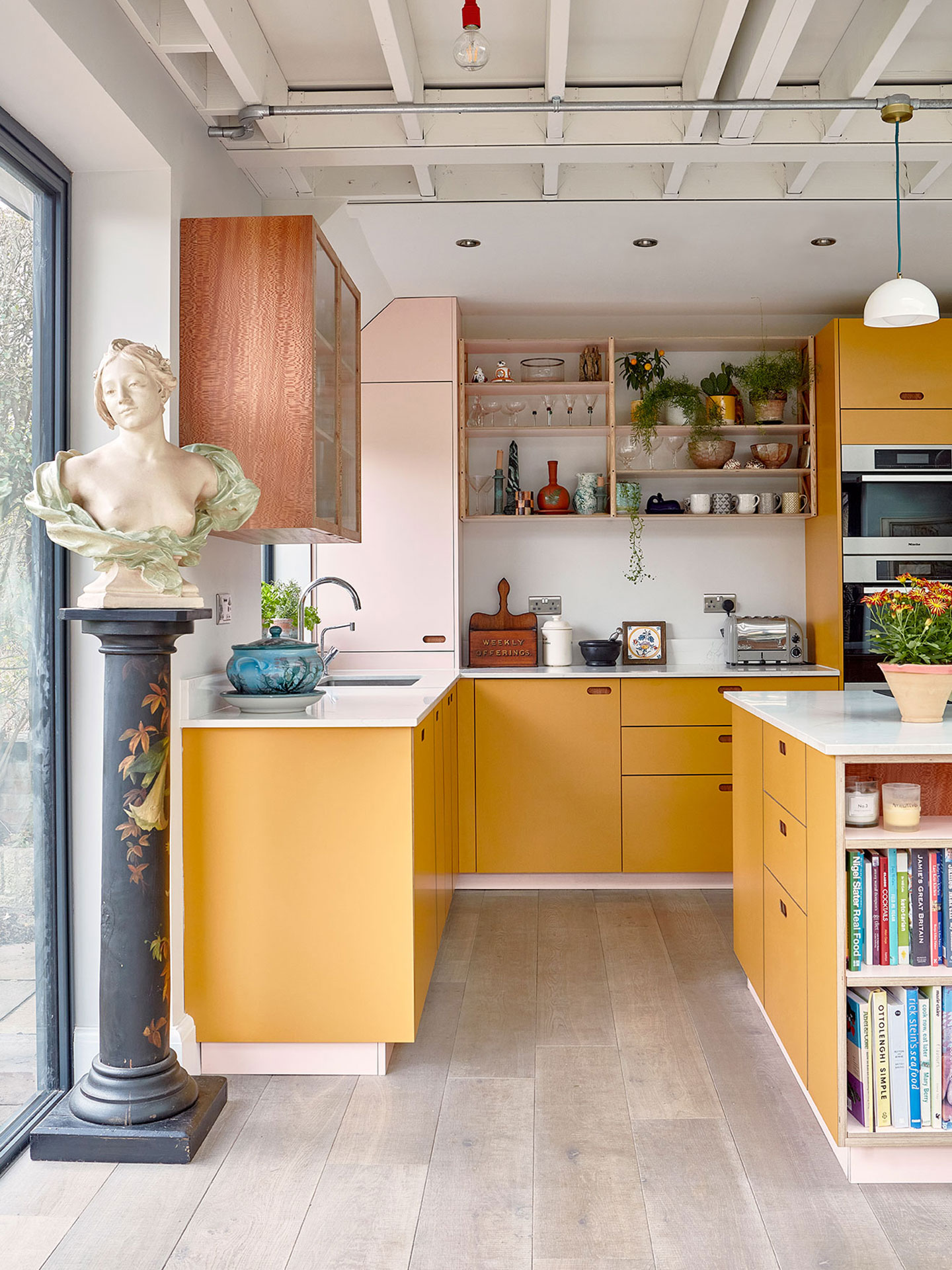 Colourful family kitchen in Birmingham including soft pink, mustard yellow and Cherry and London Plane wood Pluck cabinets.