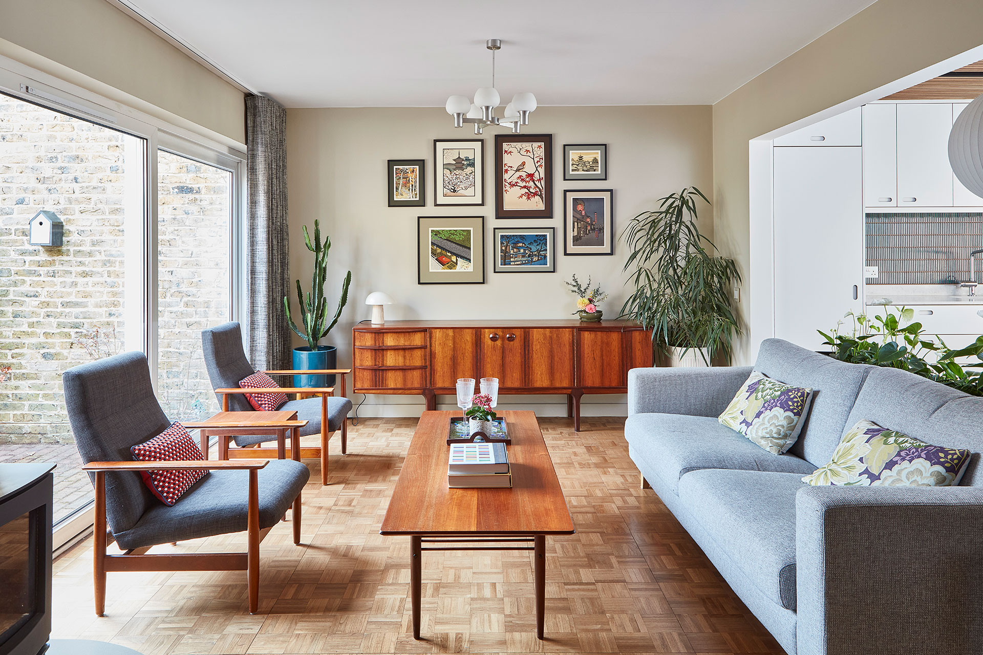 Modernist living room with parquet flooring and mid century furniture.