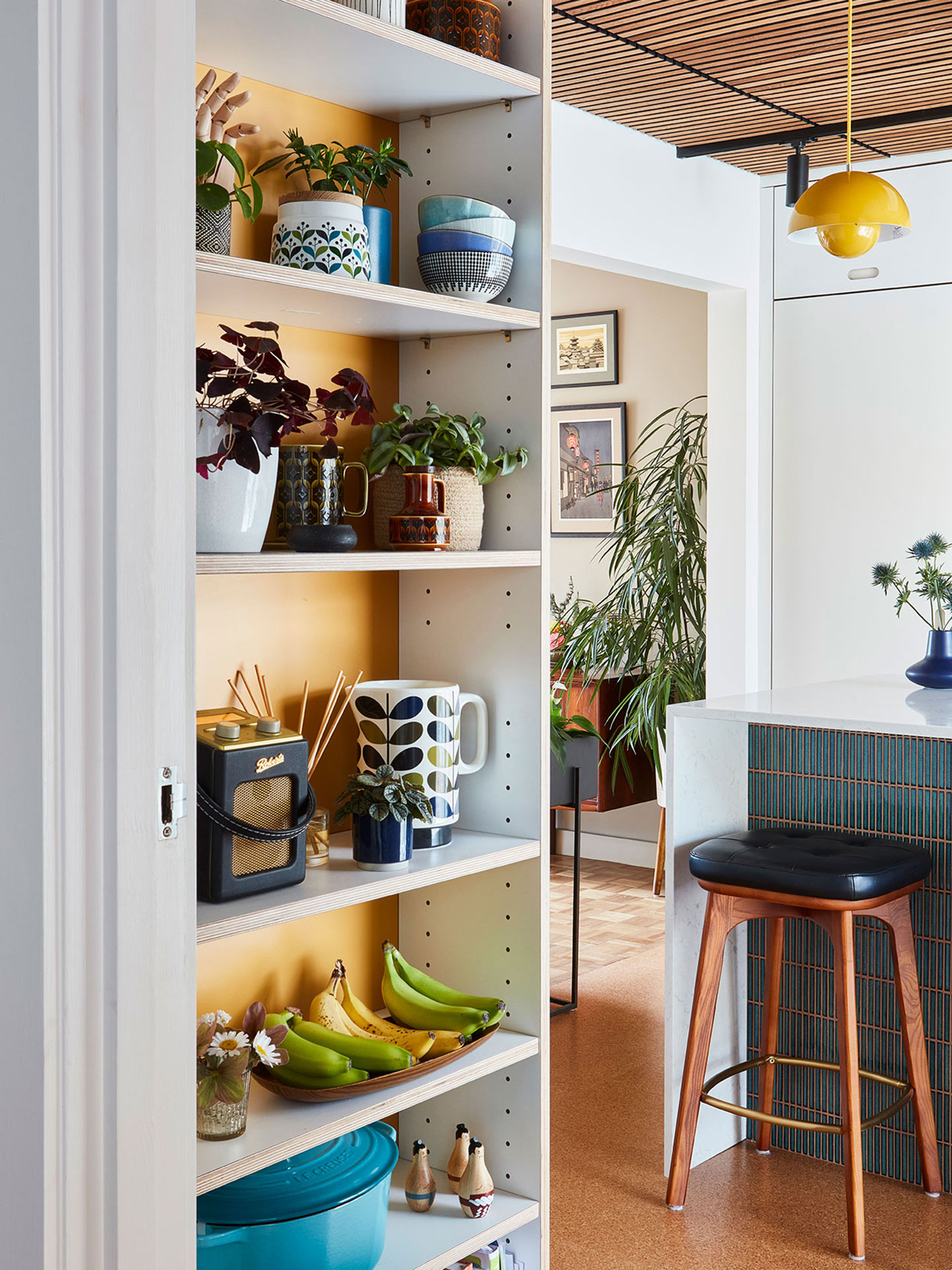 Modernist Pluck kitchen in Surrey with white cabinetry including an island.