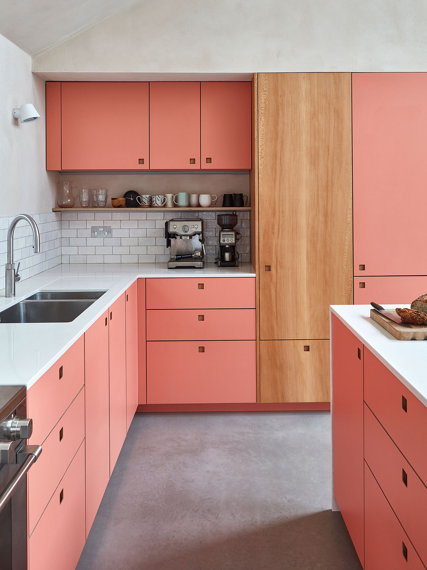 New Forest eco home with London Plane wood and coral pink cabinets.