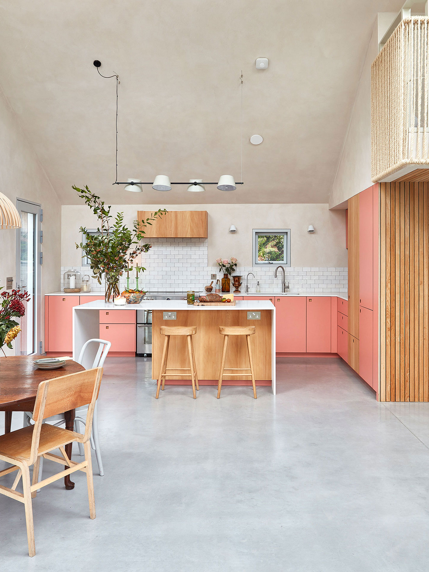 New Forest eco home with London Plane wood and coral pink cabinets.