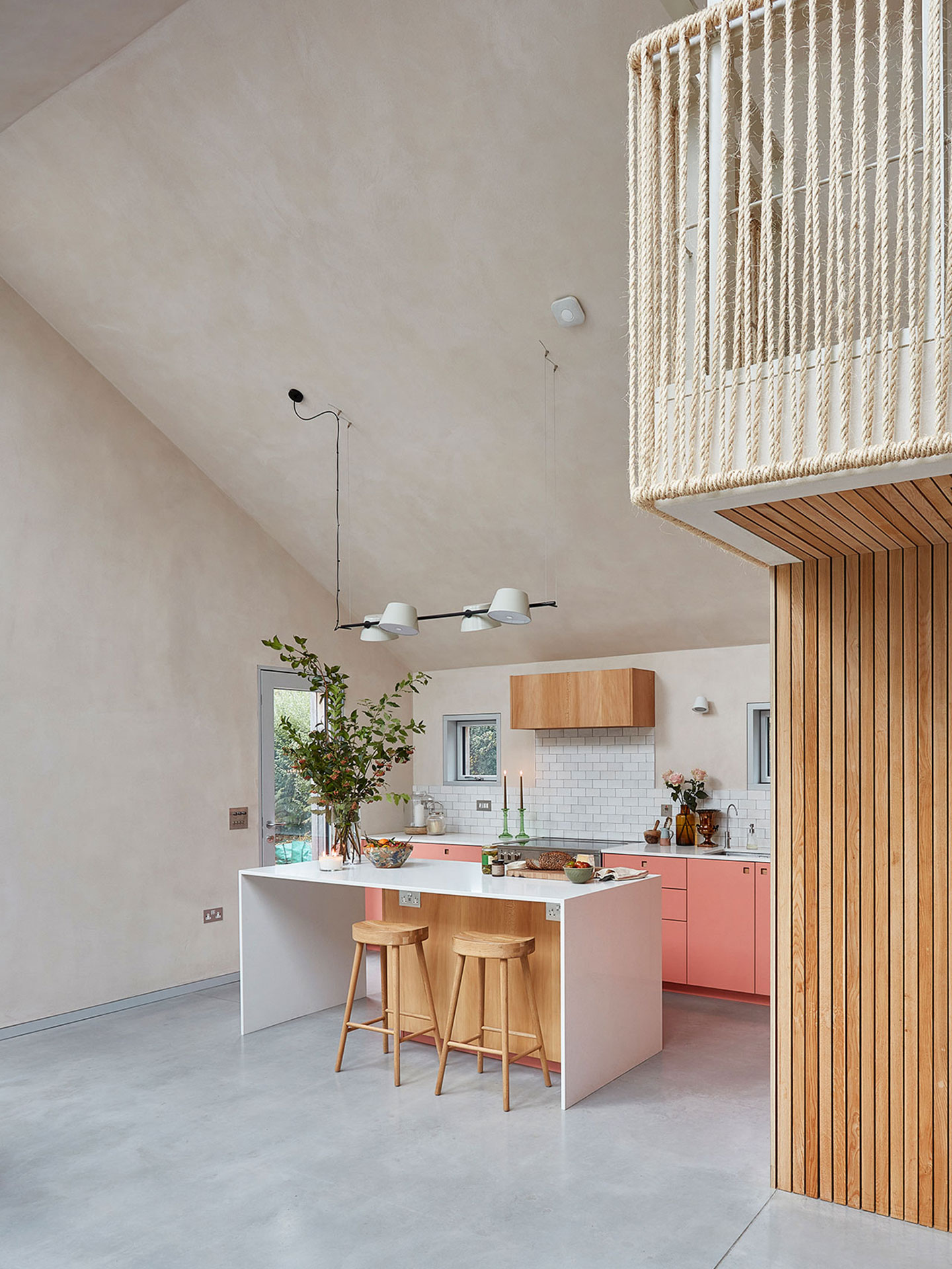 New Forest eco home with London Plane wood and coral pink cabinets.