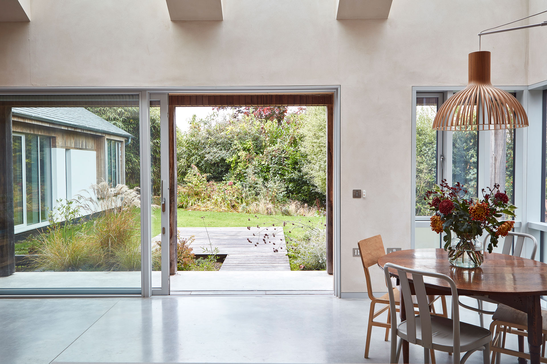 Dining area in a New Forest eco home with a Pluck kitchen.