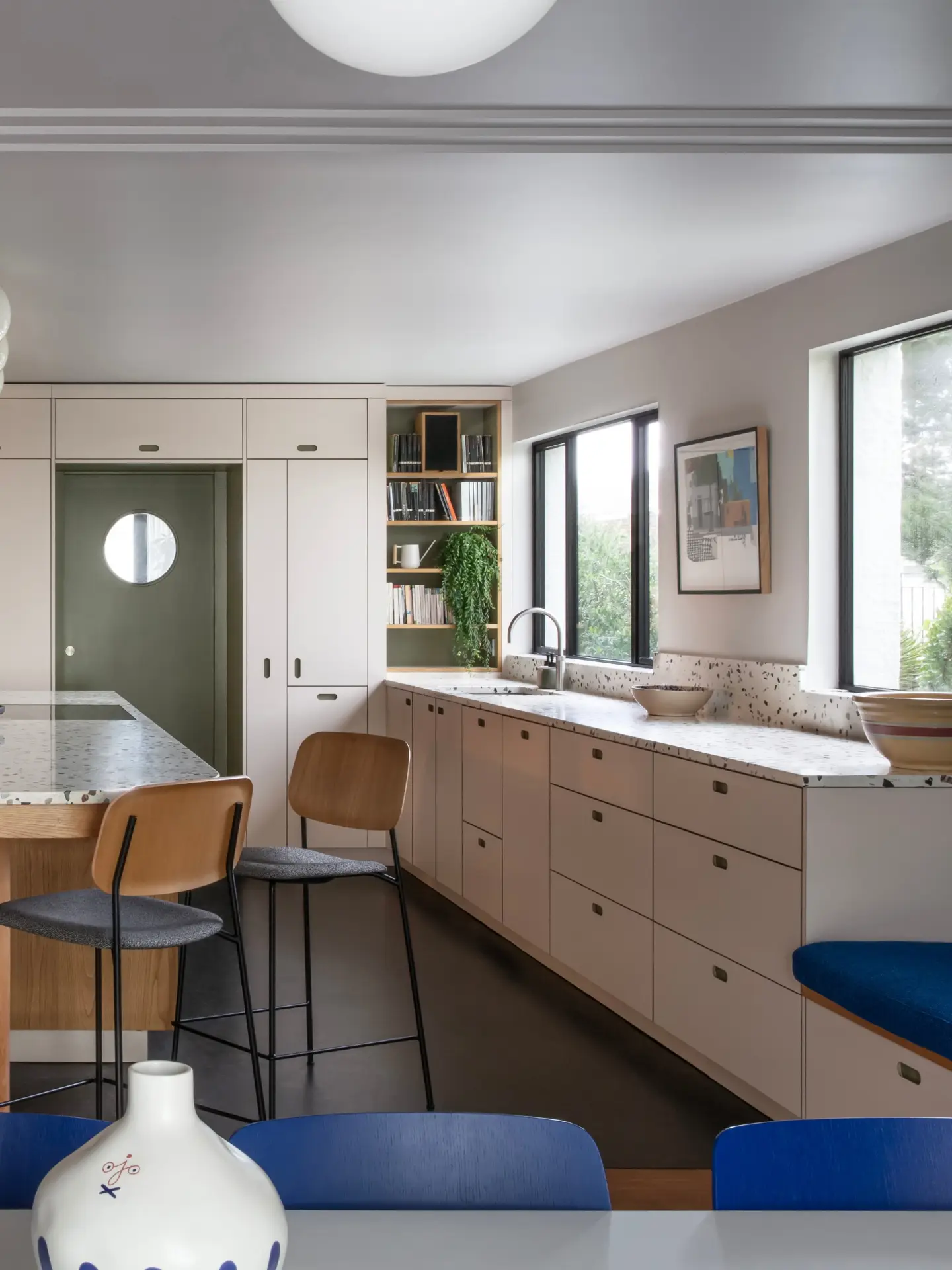 1930's seaside bolthole in Sussex including a soft beige, khaki green and Sweet Chestnut wood kitchen topped with terrazzo.