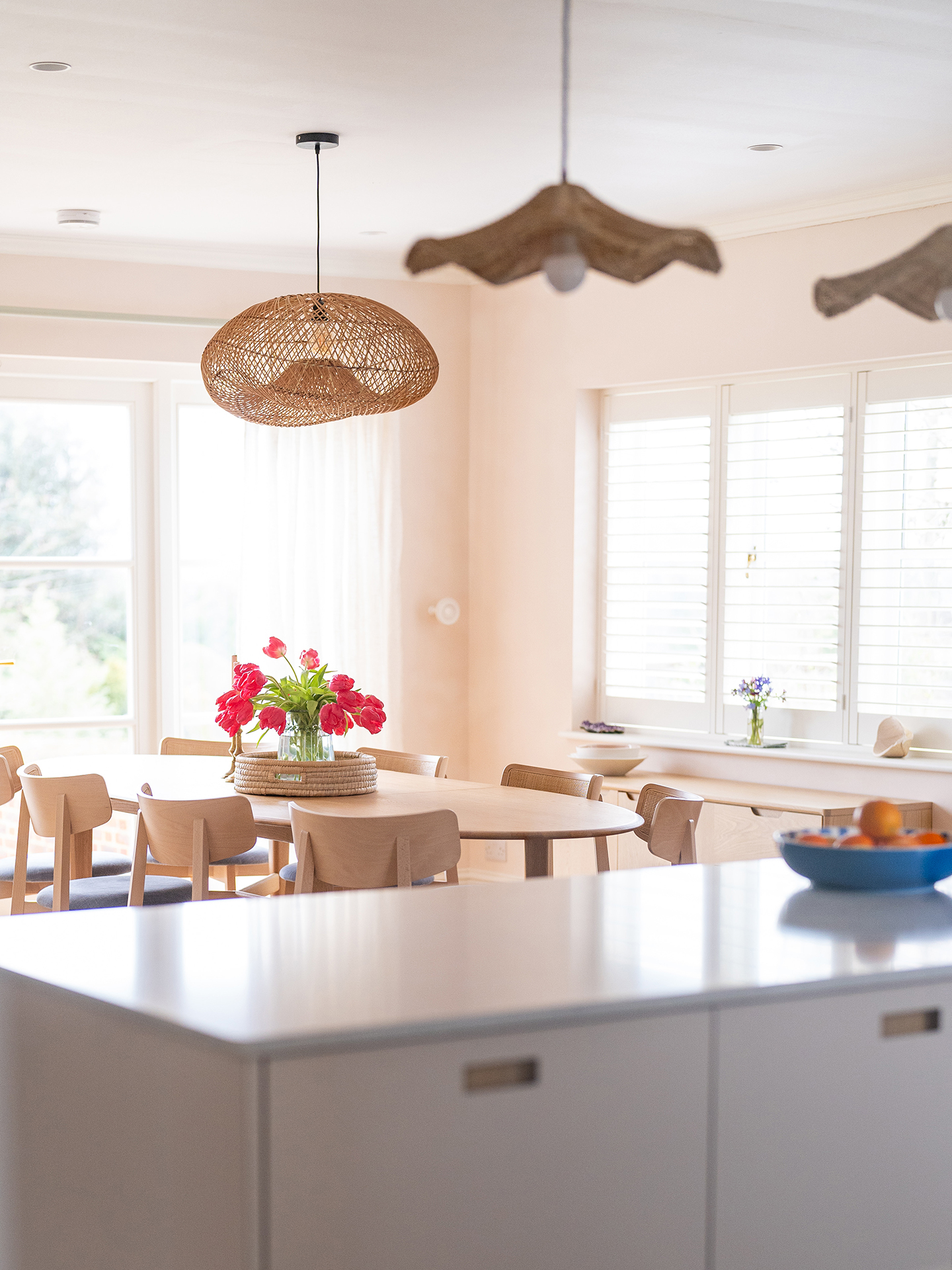 An open plan home in the Surrey Hills with pale beige and Sweet Chestnut wood Pluck cabinetry.