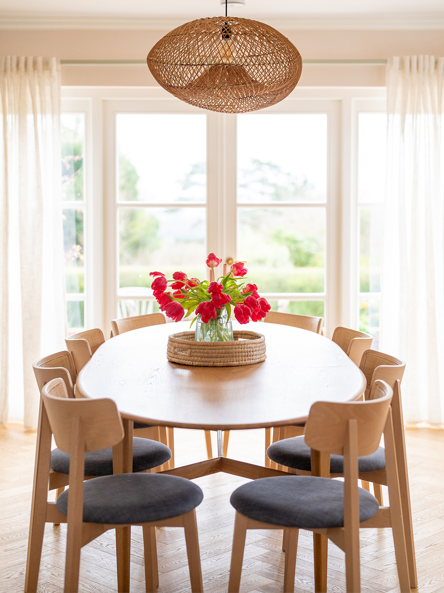 Gorgeous dining area in an open plan home in the Surrey Hills with pale beige and Sweet Chestnut wood Pluck cabinetry.
