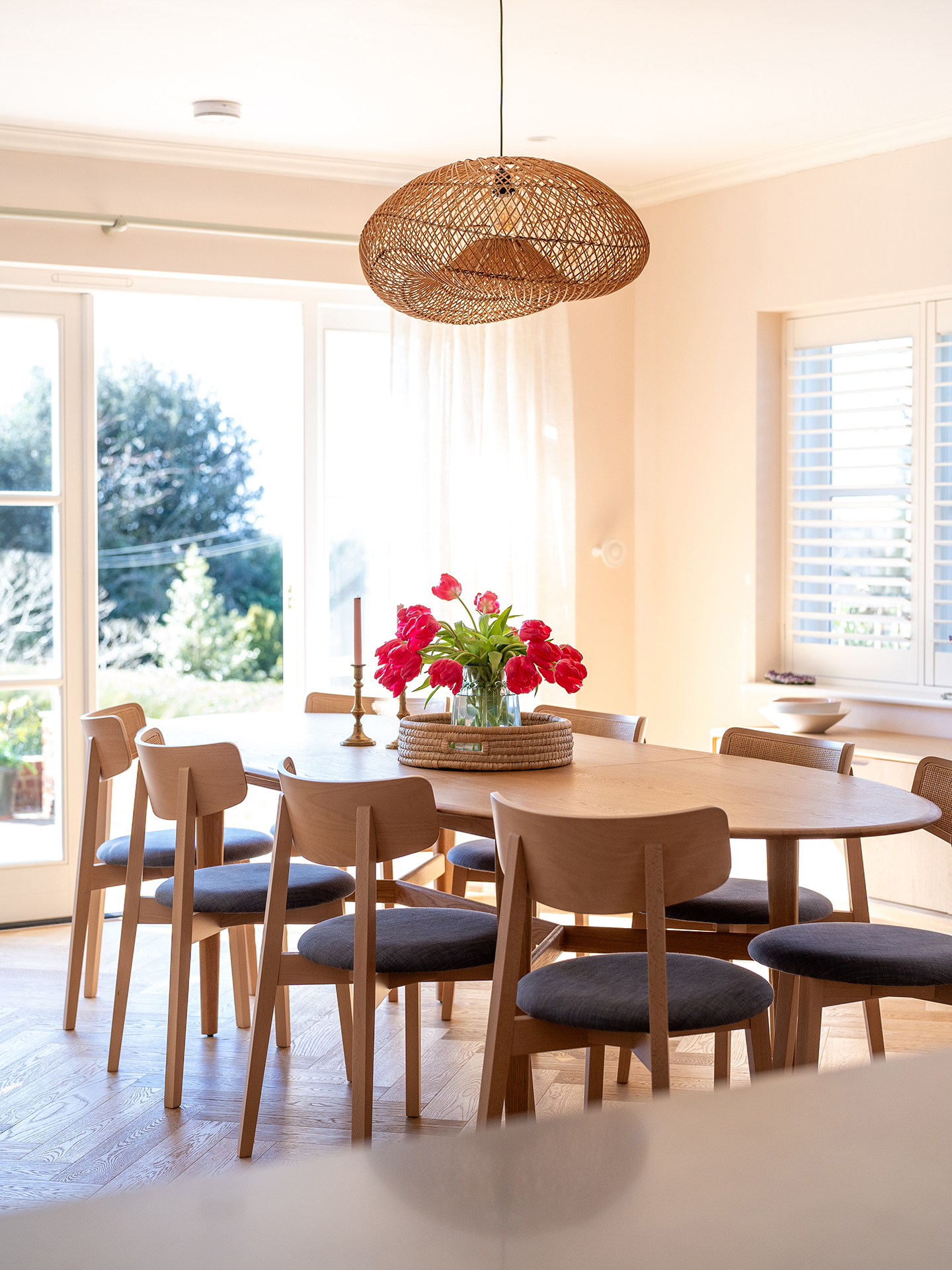 Gorgeous dining area in an open plan home in the Surrey Hills with pale beige and Sweet Chestnut wood Pluck cabinetry.