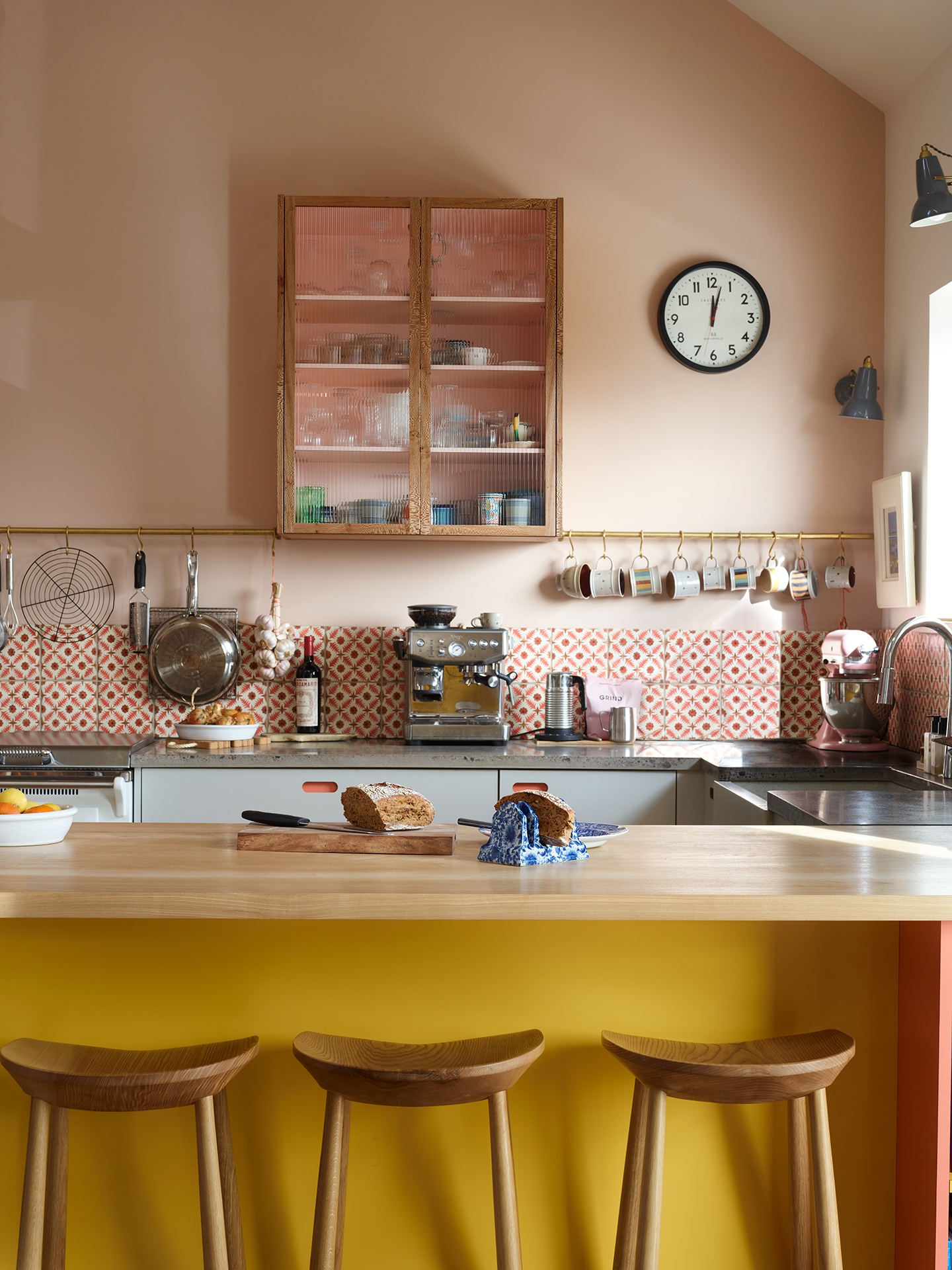 Pink, yellow and grey open plan Pluck kitchen in a family home on the Isle of Skye with spectacular views.