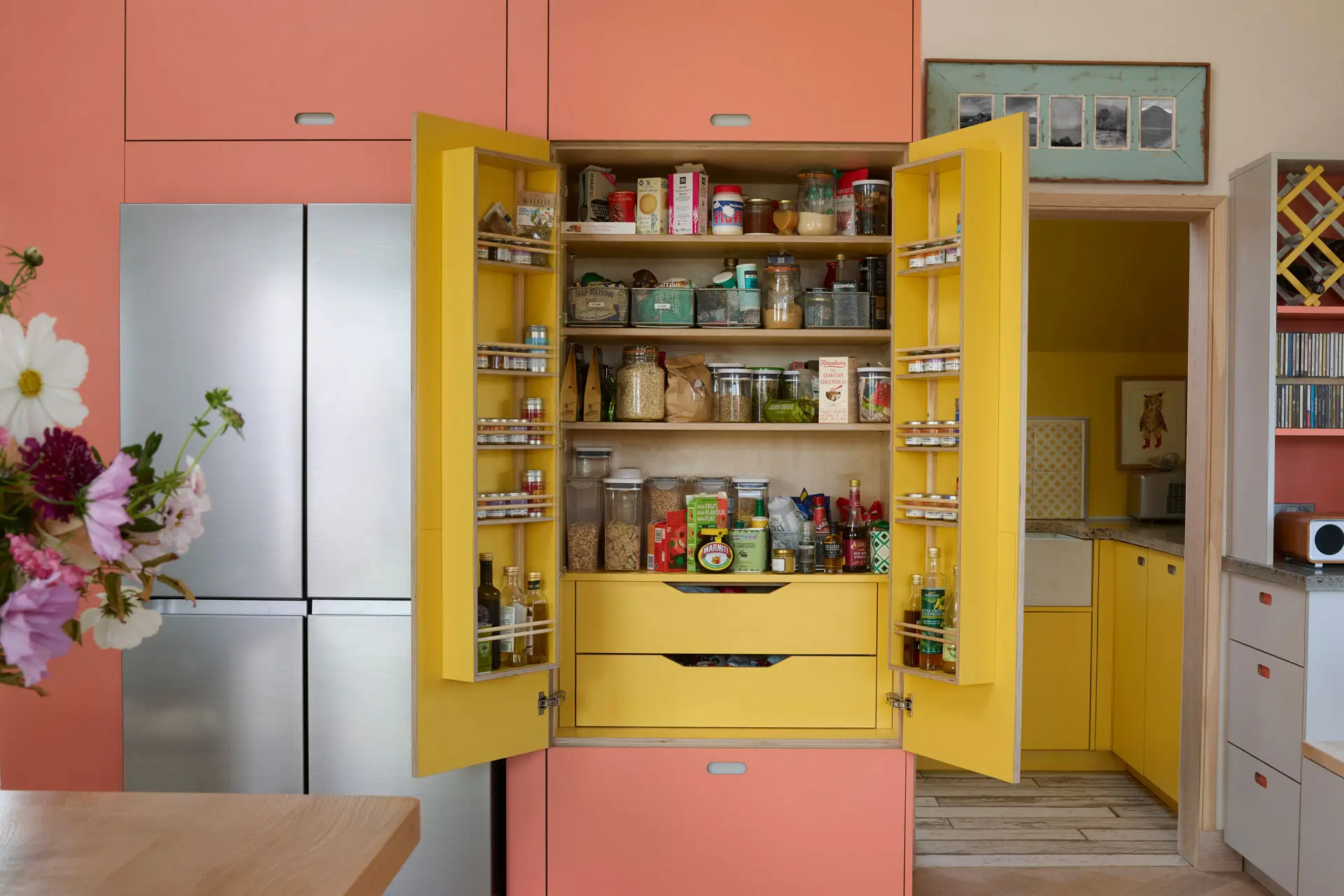 Pink, yellow and grey open plan Pluck kitchen in a family home in the Isle of Skye.
