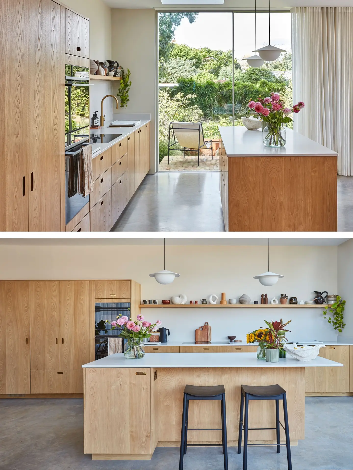 A kitchen in a family home in Brighton with wood cabinetry and brass handles, including an island, larder and shelf and grey concrete floor.