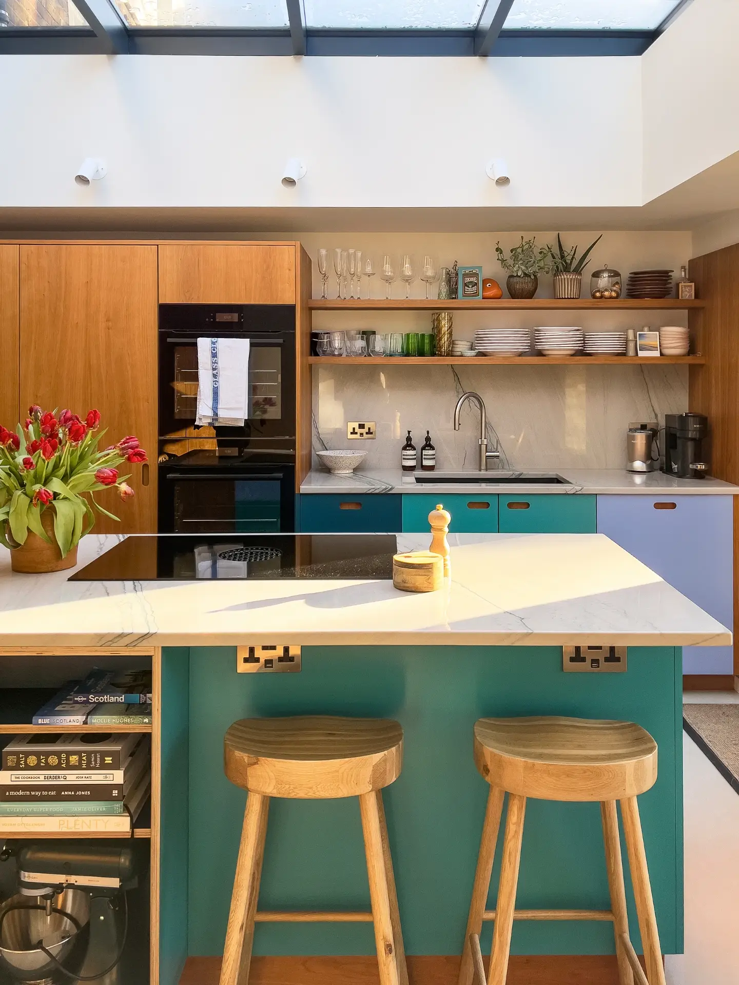 Shades of blue and Cherry wood Pluck cabinetry topped with swirling natural stone marble in a Grade II listed Victorian townhouse.
