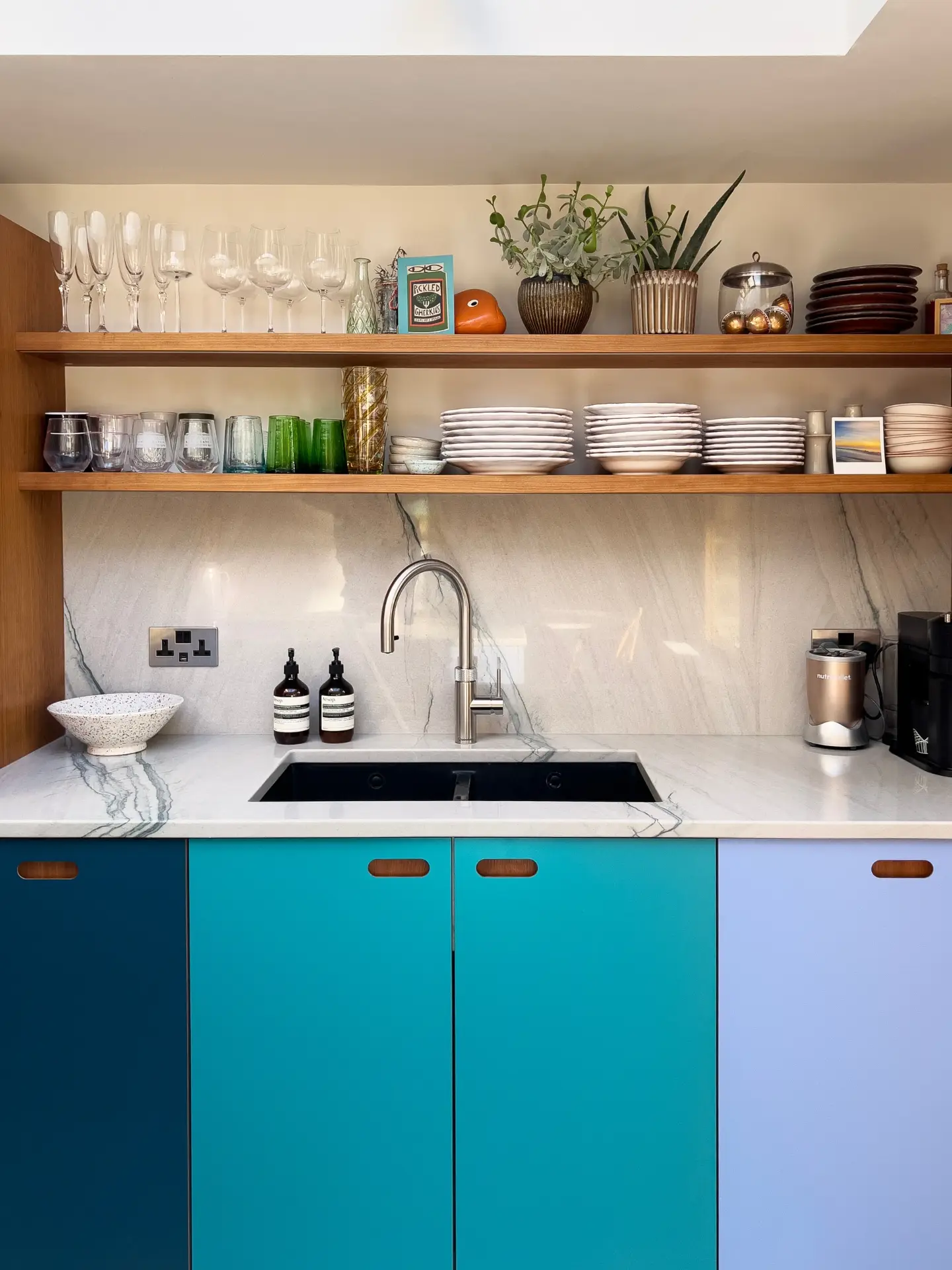 Shades of blue and Cherry wood Pluck cabinetry topped with swirling natural stone marble in a Grade II listed Victorian townhouse.