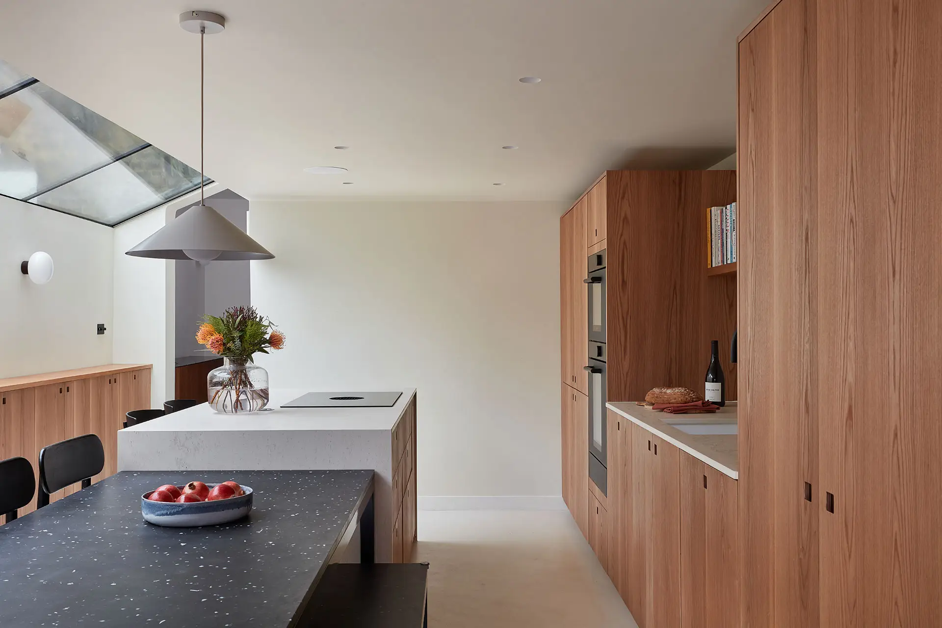 Warm Elm wood Pluck cabinetry including an island in an open plan Nunhead home.