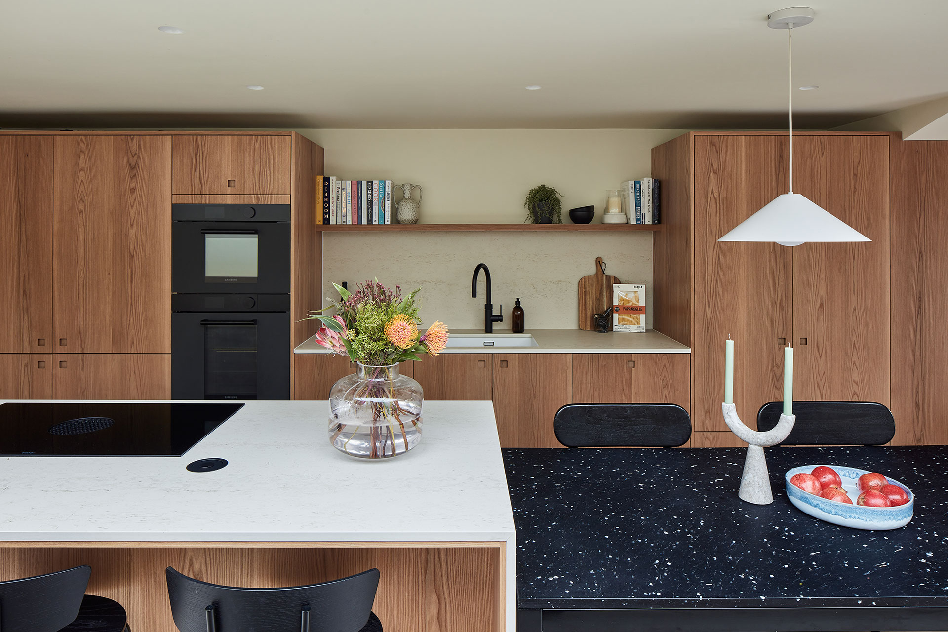 Warm Elm wood Pluck cabinetry including an island in an open plan Nunhead home.