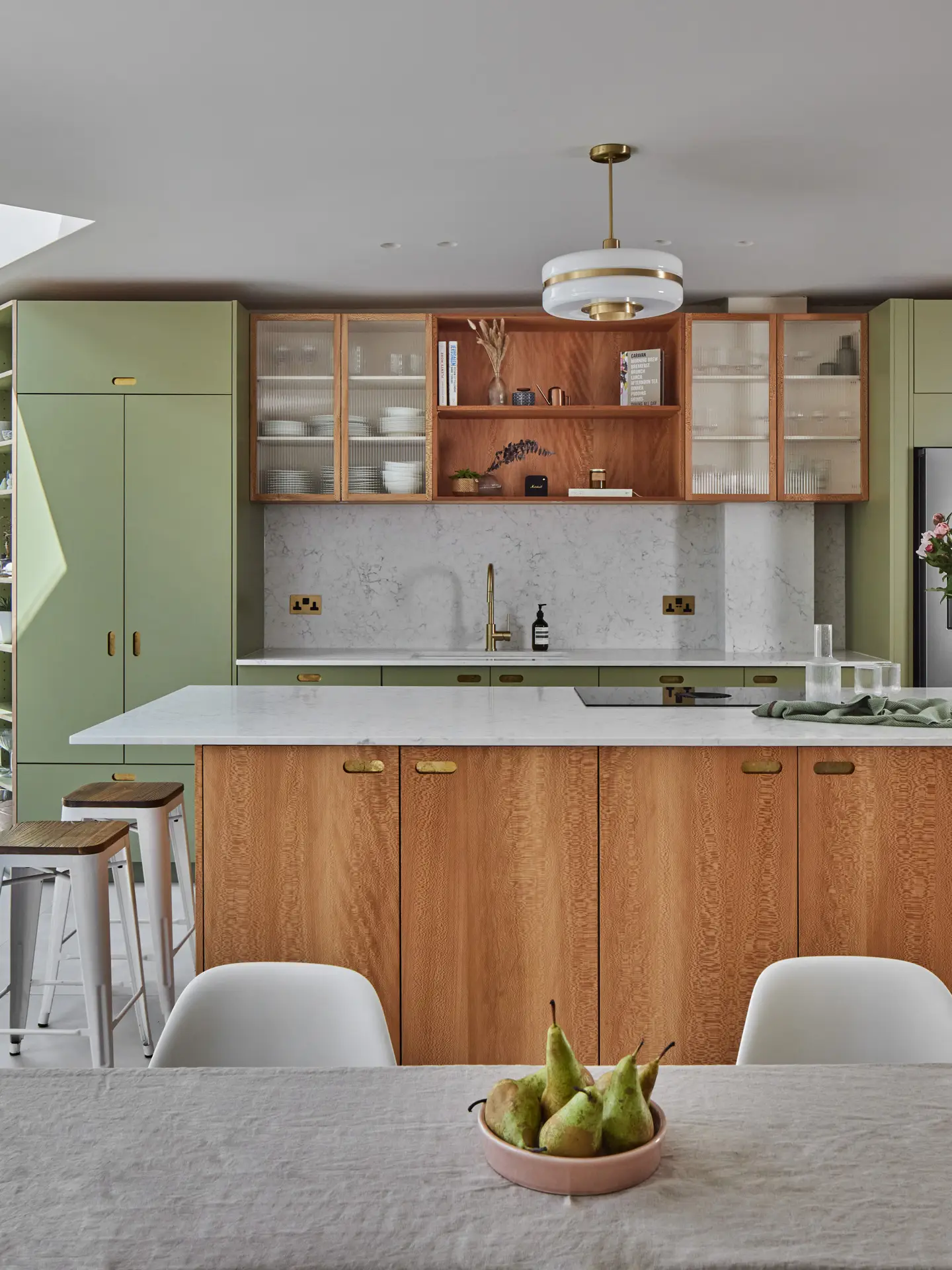 Luxe family home with a green and London Plane wood kitchen including an island and larder.