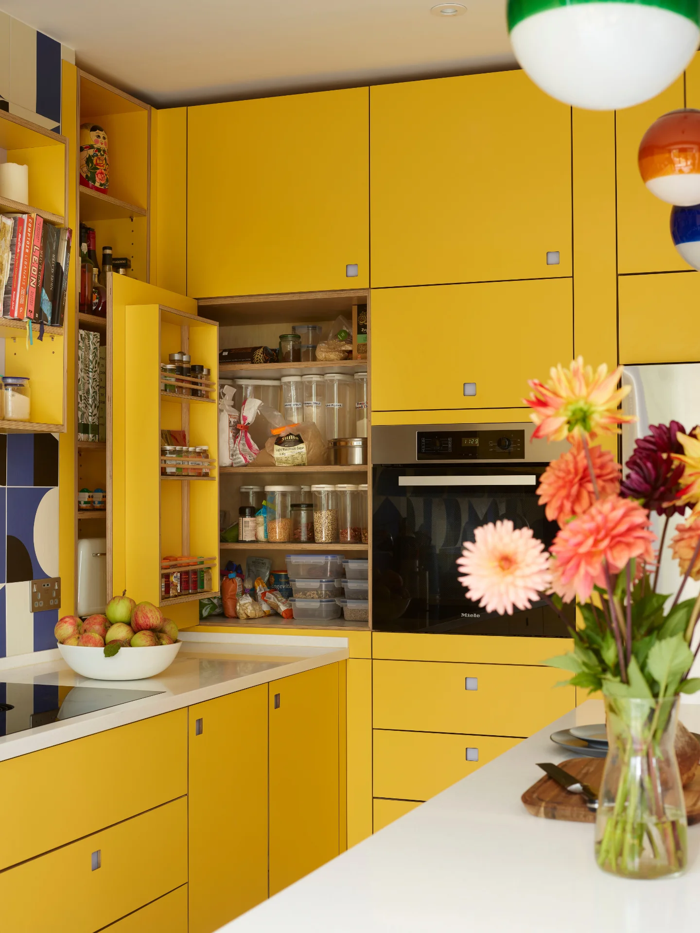 Yellow Pluck kitchen cabinetry with a small corner larder and Oak wood framed prep table.