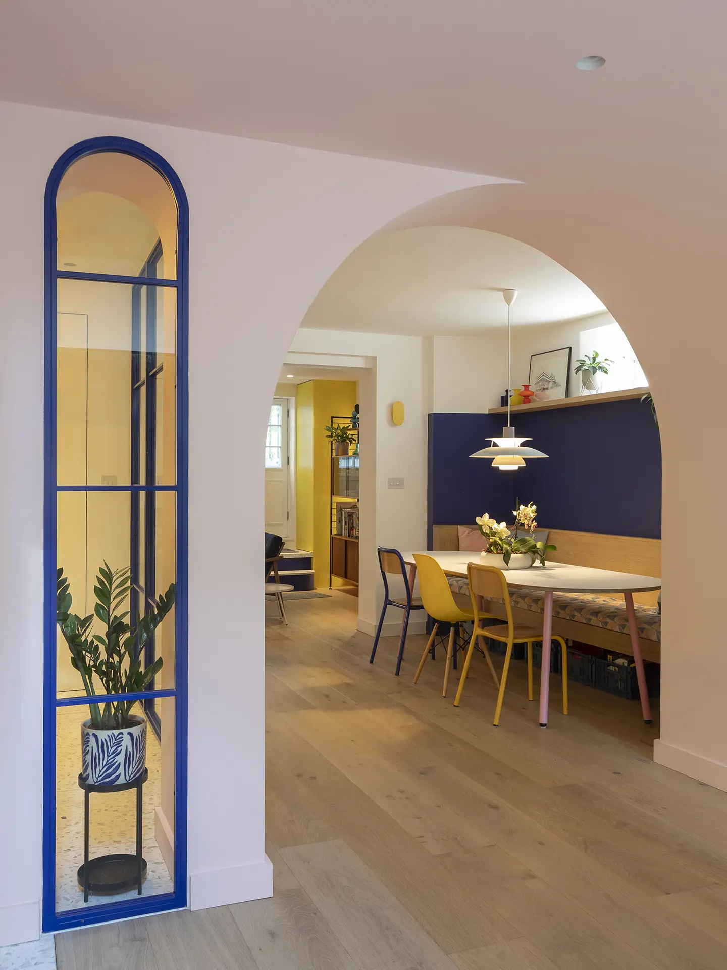 Dining table in a colourful open plan Pluck kitchen.