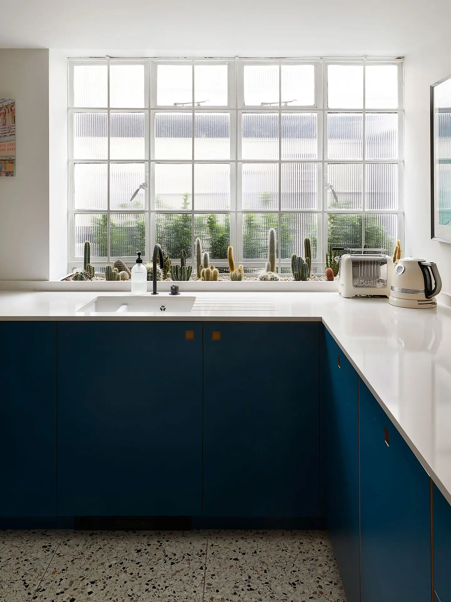 Blue, mustard yellow and wood Pluck kitchen in a Westminster townhouse basement.