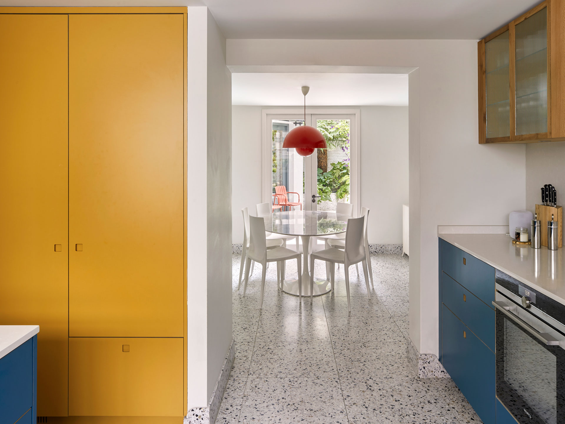 Listed Victorian townhouse in Westminster with a bright blue, mustard yellow and London Plane wood basement kitchen and terrazzo floor.