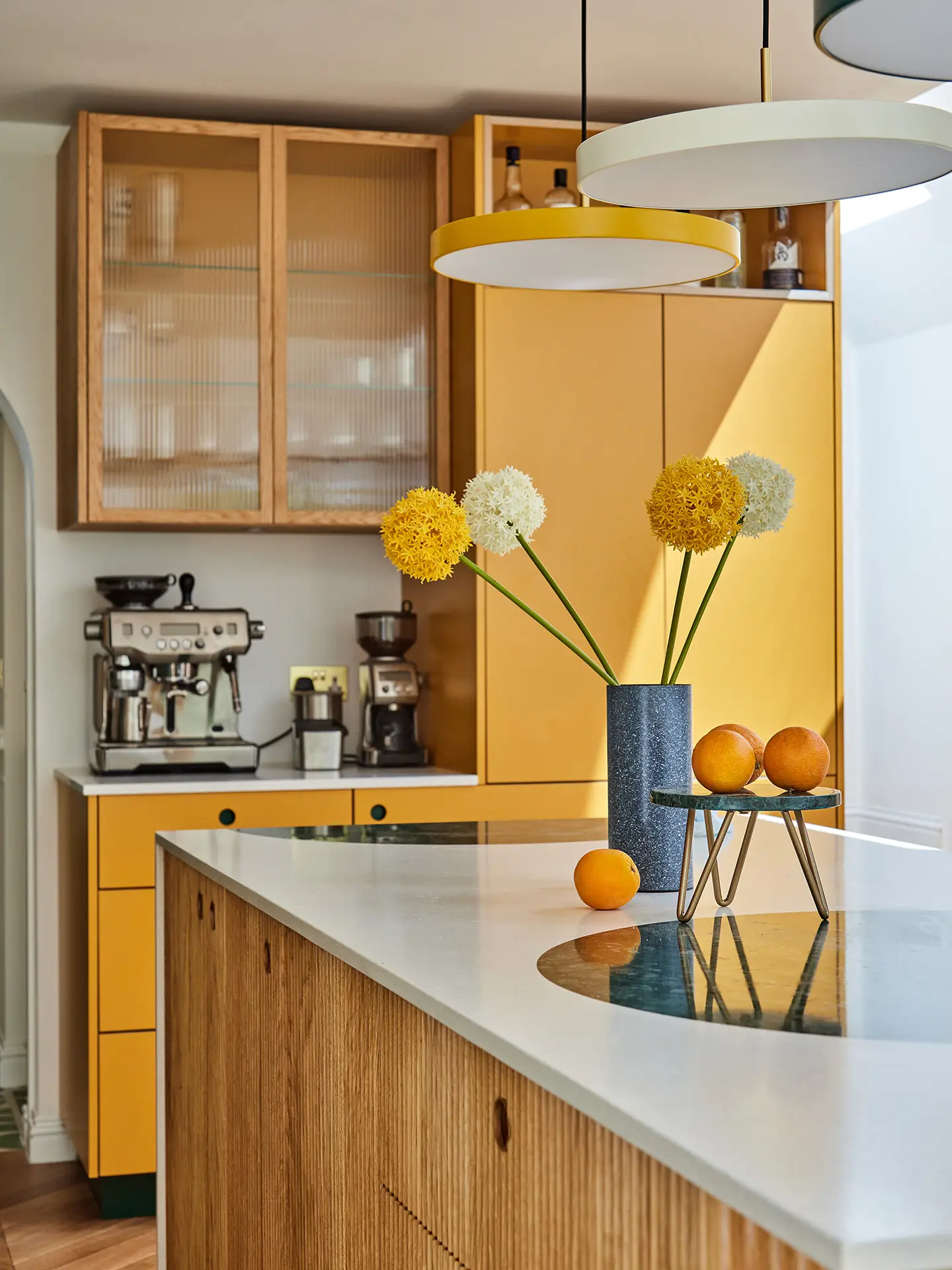Kitchen with a colourful palette including dark green and sunshine yellow with warm Oak wood.