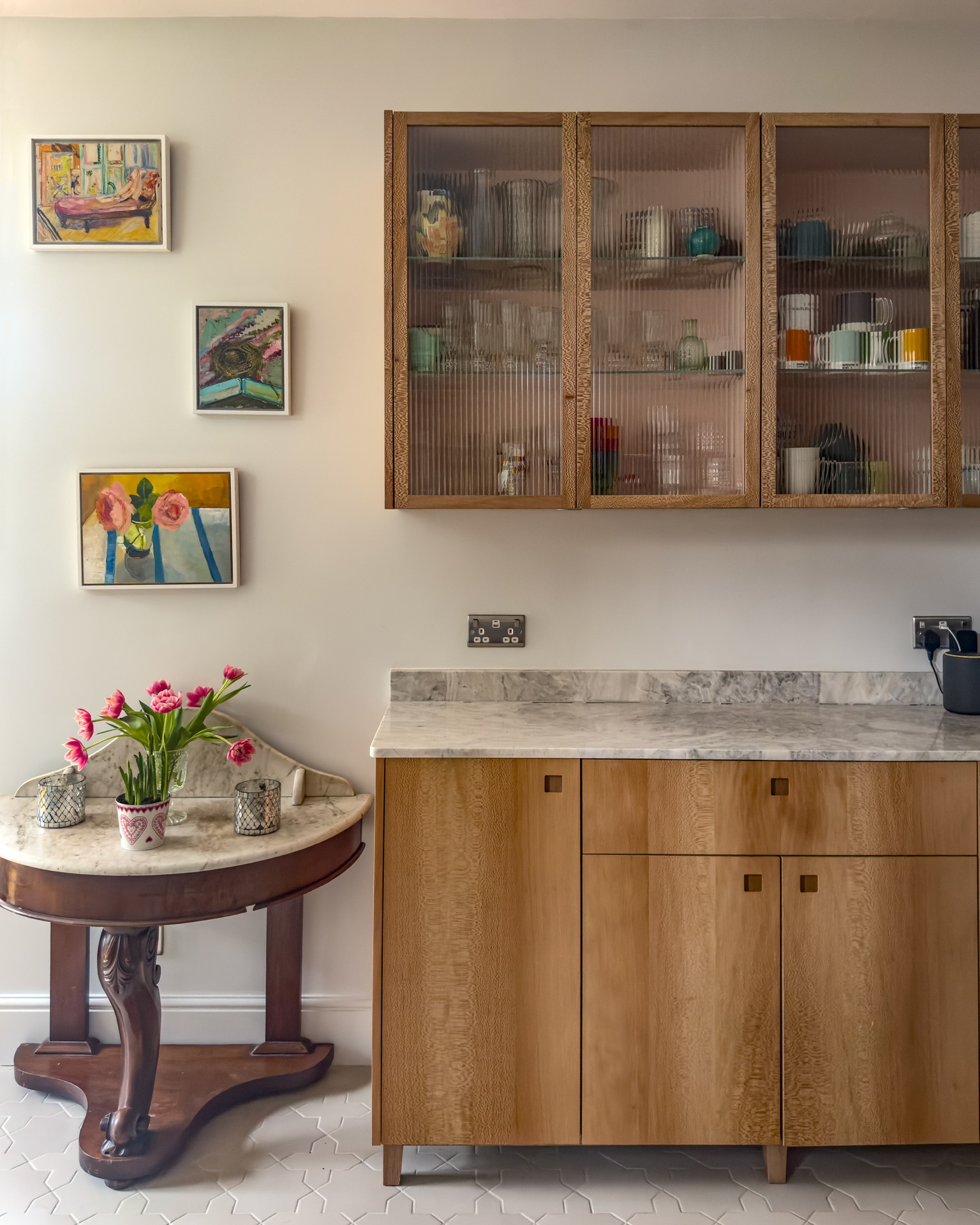 Closeup of a kitchen with glass cabinets.