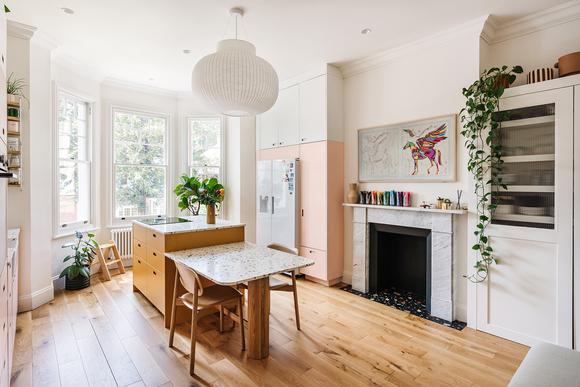 Set in a Victorian terrace, this pink kitchen is home to a young family who wanted to create pretty practical room with plenty of storage and a dining table.