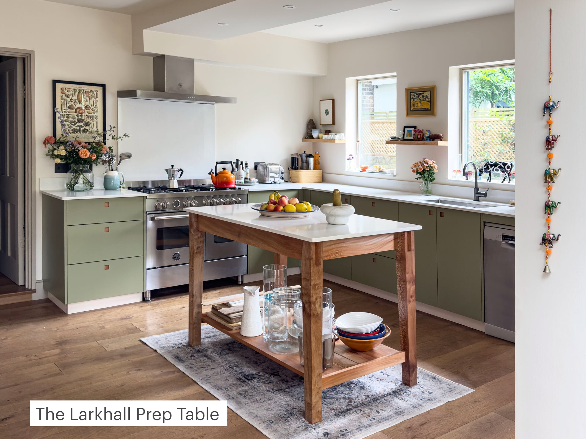Kitchen prep table with timber legs and a stone top.