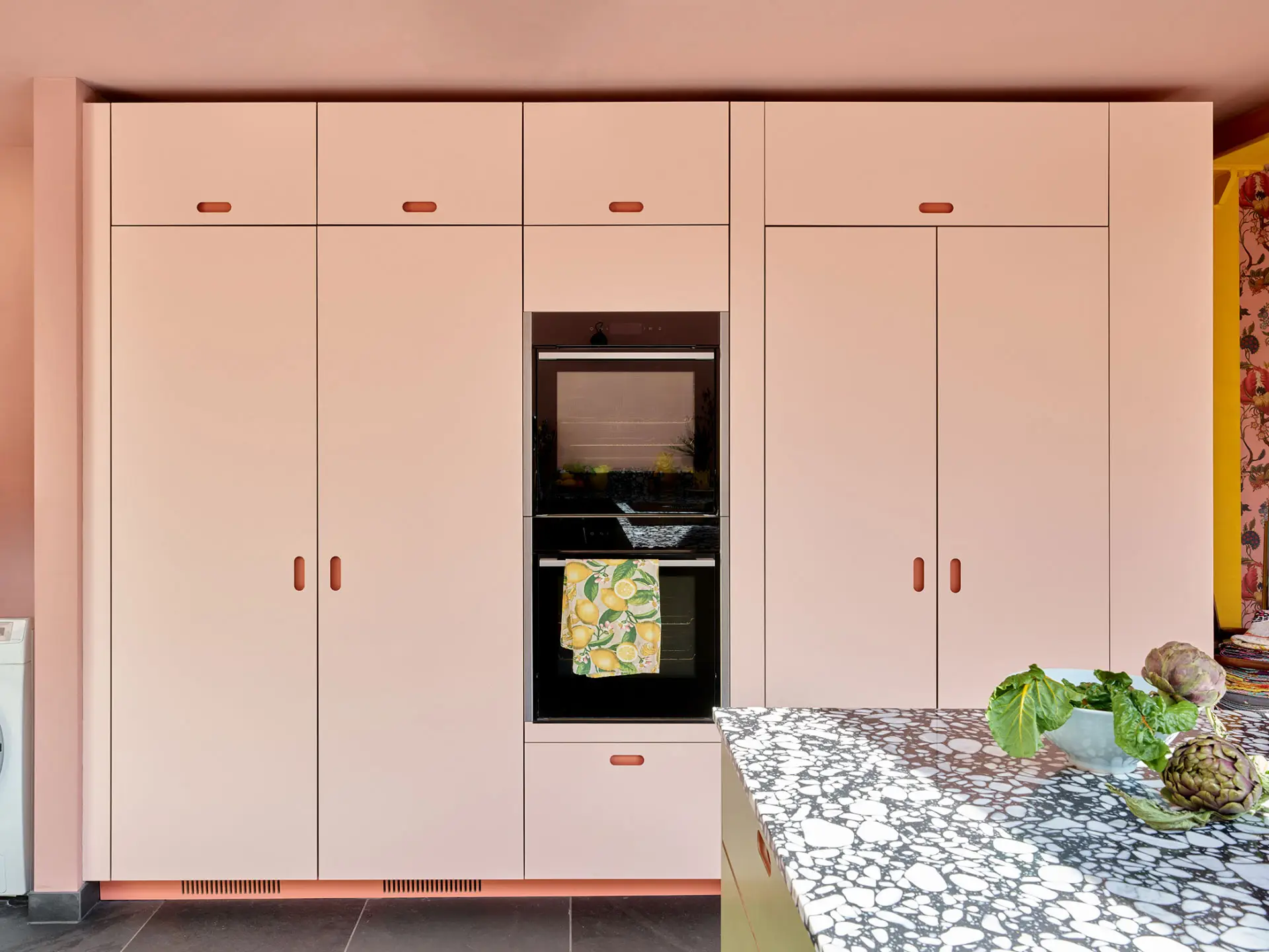 A colourful London kitchen with Pluck's cabinetry in an open plan room that is fun, cosy, calming and inviting.