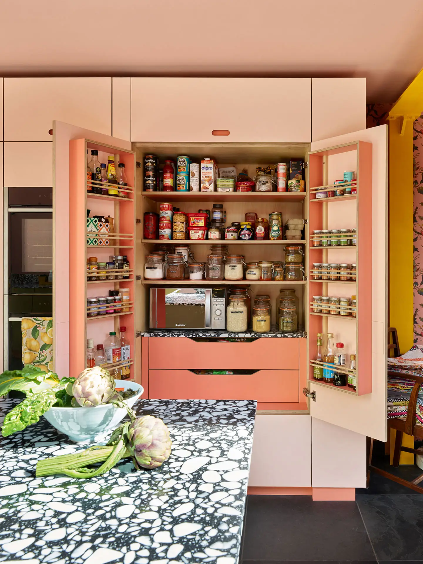 A colourful London kitchen with Pluck's cabinetry in an open plan room that is fun, cosy, calming and inviting.