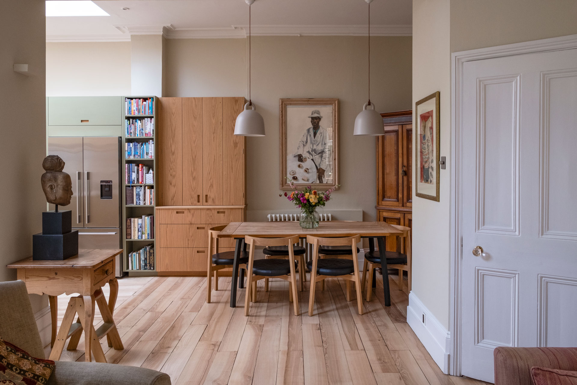 A Victorian home in Stockwell with Brockwell Moss green and oak wood cabinetry including a bi-fold cupboard.