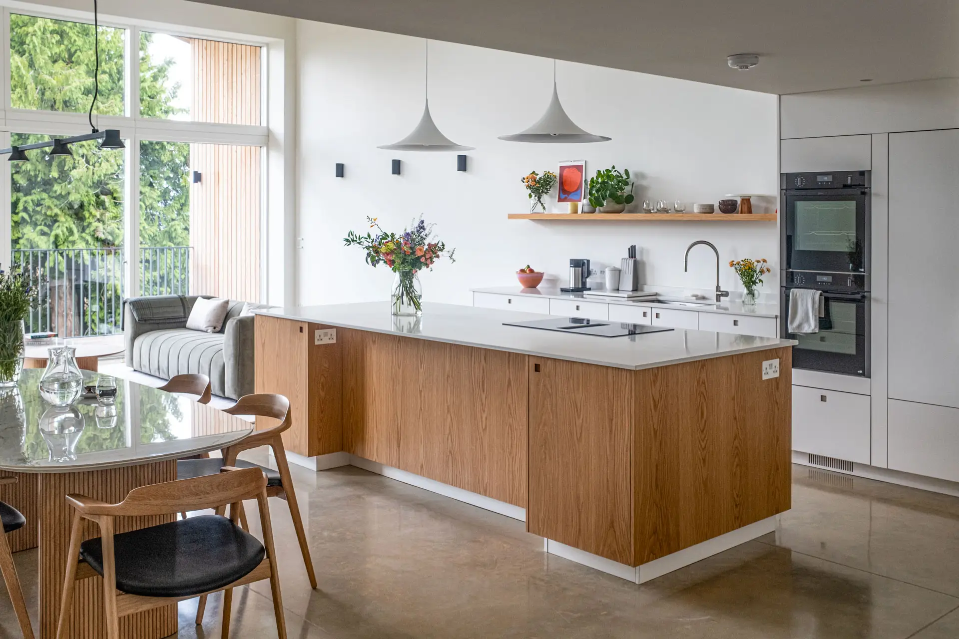 White and Oak wood custom cabinetry in a Pluck kitchen with an island and larder in Cheltenham.